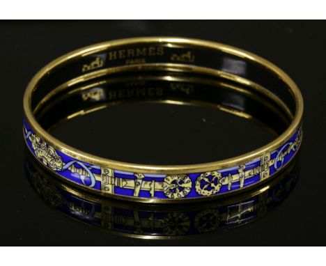An Hermès narrow blue enamel gold-plated bangle,with printed belt and bucket design, stamped 'Hermès Paris, Made in Austria'