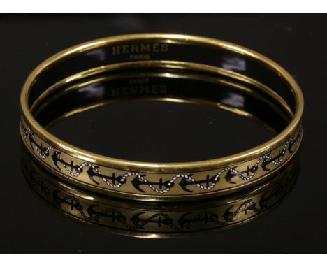 An Hermès narrow gold ground enamel gold plated bangle, with printed anchor design, stamped 'Hermès Paris, Made in Austria'