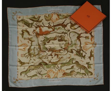 An Hermès silk scarf, 'Premieres Mains', designed by Zoe Pauwels, pale blue ground with a printed animal design, with ribbon 