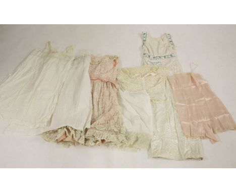 A child's pink taffeta and lace evening dress,early 20th century, with a pink taffeta sash,a cream grosgrain sleeveless eveni