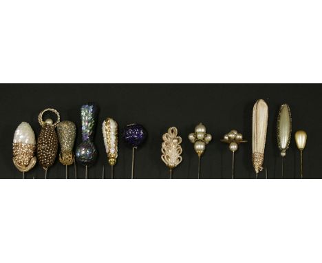A large collection of Edwardian and Art Deco hatpins,to include:a Scottish pebble example, with a lobed surround of granite i