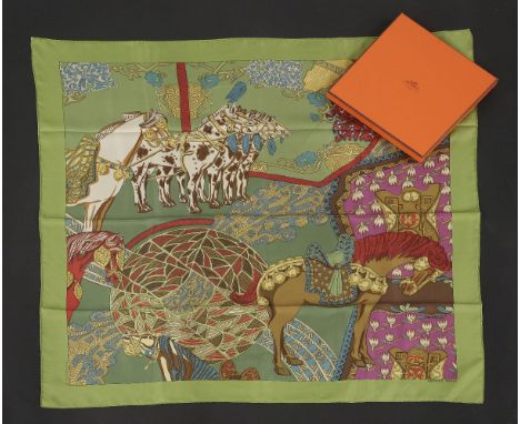 An Hermès silk scarf,'Art des Steppes', designed by Annie Faivre, green ground with an animal design, with ribbon, in box and