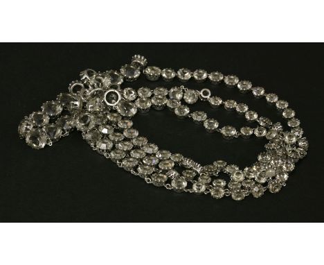 A Christian Dior three-row graduated paste rivière,c.1960, with three rows of circular faceted smoke-grey claw set paste to a