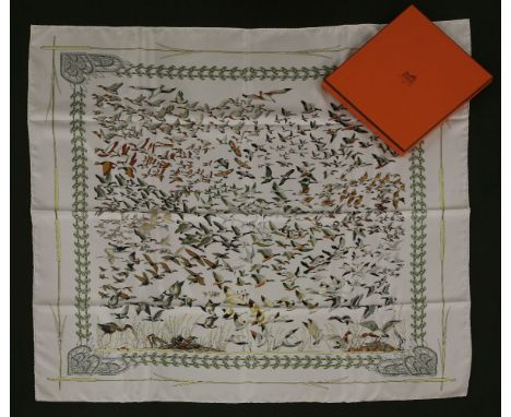 An Hermès silk scarf,'Libres Comme L'Air', designed by Annie Faivre, white ground with printed design of birds in flight, in 