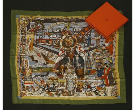 An Hermès silk scarf,'Tsitsika', designed by Kermit Oliver, green ground with a multicoloured Native American design, in a bo