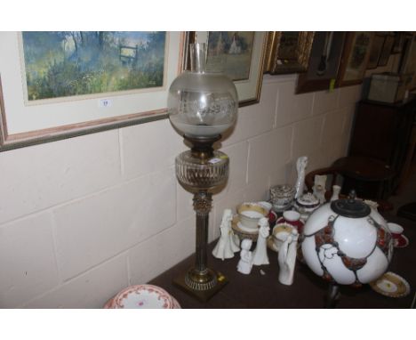 A brass Corinthian column table oil lamp with clear glass font and etched shade 