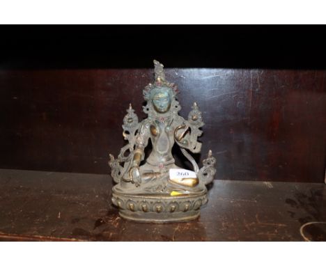 A bronze Oriental figure of a seated Goddess