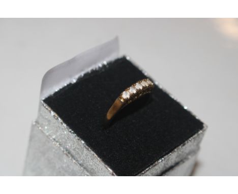 A gold plated and white stone set ring 