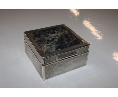 A silver engine turned and wooden lined decorated and labradorite topped cigarette box 