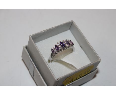 A Sterling silver, Cubic Zirconia and amethyst coloured stone set ring, size P/Q