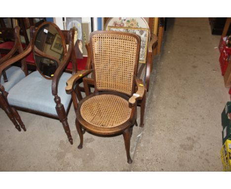 A 1930's beech elbow chair with cane panel seat and back