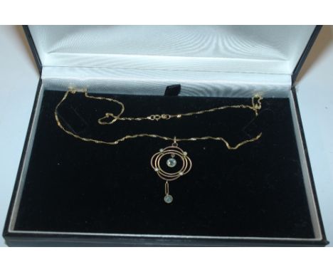 A 9ct gold pendant set with seed pearl hung to a fine link chain 