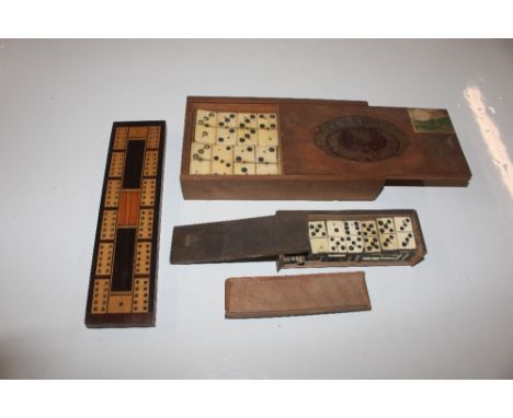 Two sets of antique bone dominoes and a cribbage board