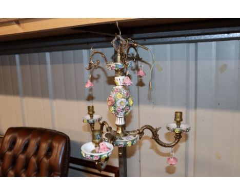 A floral encrusted decorative three light chandelier 