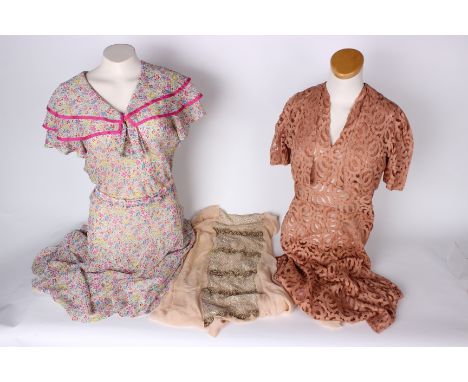 A pale brown lace dress with matching bolero jacket, a pink chiffon dress with a silver metallic lace panel, a white short sl