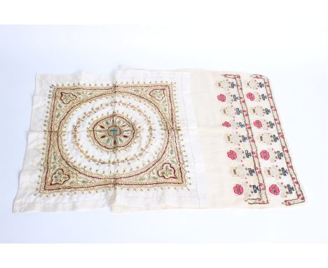 A late Ottoman Turkish towel; embroidered at each end with alternate pink and cream flowers and gold metallic flat stitch det