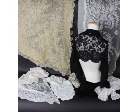 A collection of late 19th early 20th Century lace including; a pair of lace panels, a lace cap, a large panel of lace, a blac