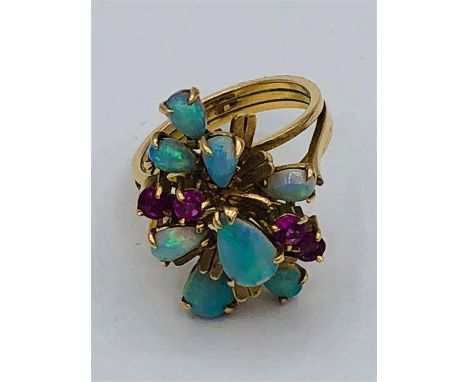 A 14ct yellow gold ruby and opal cluster ring.