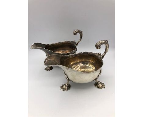 A pair of Georgian sauce or gravy boats on three feet in the form of scallop shells. 1757, London Hallmark