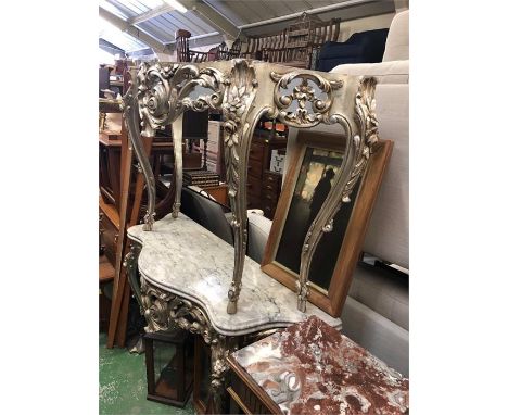 A pair of marble topped hall or console tables with carved legs in silver.