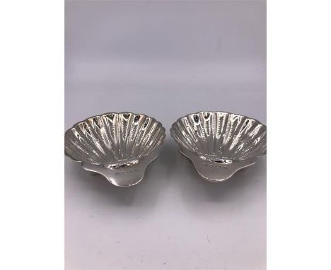 A Pair of silver butter dishes in the form of scallop shells, hallmarked Birmingham 1910 , makers mark ACMC