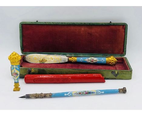 A French enamel ormolu writing set in a green leather embossed case wax seal, letter opener and pen