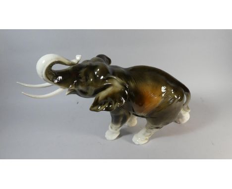 A Large Ceramic Study of An Elephant by Royal Dux with Trunk in Salute, 56cm Long 