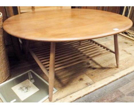 A large oval light elm Ercol coffee table 