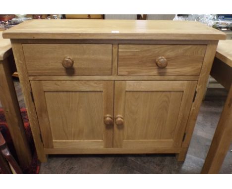 New good quality solid light oak sideboard fitted cupboards and  two drawers with bun handles. 3'3" wide 