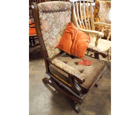 A mahogany framed rocking elbow chair in tapestry covering 