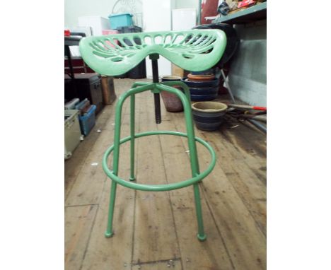 A green cast tractor seat stool 