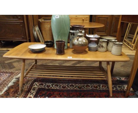 A long Ercol light elm coffee table 