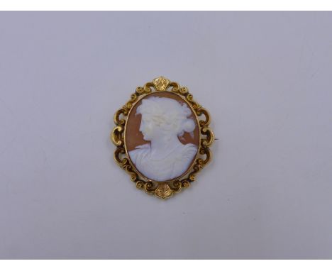 A CARVED PORTRAIT CAMEO IN A PRECIOUS YELLOW METAL SCROLL MOUNT TESTED AS GOLD. APPROXIMATE MEASUREMENTS 4.5cms x 5.5cms (INC