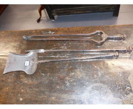 A SET OF THREE ARTS AND CRAFTS WROUGHT IRON FIRESIDE TOOLS.