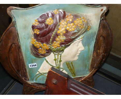 A.MEISSNA.  (EARLY 20th.C).  A CERAMIC ART NOUVEAU STYLE PLAQUE OF A YOUNG WOMAN IN PROFILE, STAMPED AUSTRIA.   H.48cms.