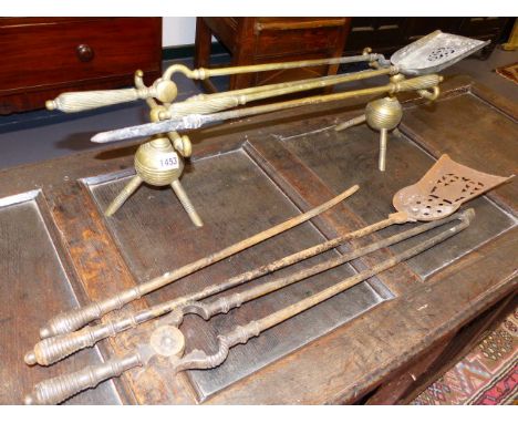 A PAIR OF CHRISTOPHER DRESSER DESIGN BRASS ANDIRONS, A SIMILAR SET OF BRASS FIRE TOOLS AND A SET OF STEEL FIRE TOOLS.