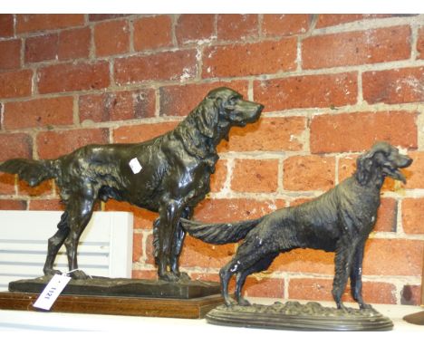 THREE ANIMALIER TYPE FIGURES OF DOGS, TWO SETTERS AND A TERRIER AND AN IRON FORM DOG NUTCRACKER.   LARGEST OVERALL H.38cms.  