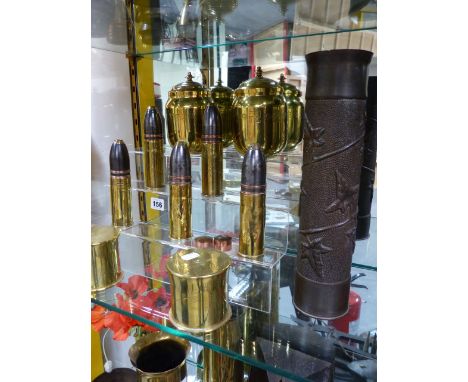 A GROUP OF VARIOUS TRENCH ART DECORATED SHELL CASES AND A PAIR OF TEA CANNISTERS WITH SWASTIKA DECORATION. 
