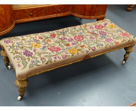 A VICTORIAN GILT FRAMED LONG STOOL WITH TAPESTRY TOP.   L.118cms x W.49cms.