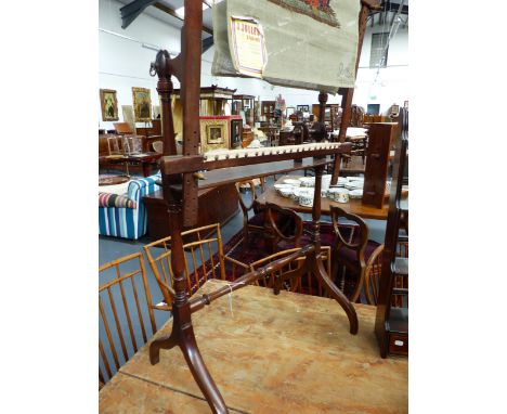 A VICTORIAN MAHOGANY TAPESTRY FRAME WITH RING TURNED SUPPORTS AND CURVED LEGS.
