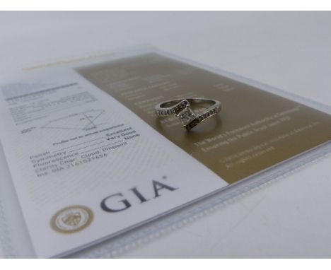 A PRINCESS CUT DIAMOND RING WITH DIAMOND SET SHOULDERS, HALLMARKED 950 PLATINUM LONDON. APPROXIMATE TOTAL DIAMOND WEIGHT 0.58