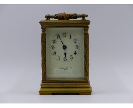 A SMALL EDWARDIAN CARRIAGE CLOCK WITH TIMEPIECE MOVEMENT AND CREAM ENAMEL DIAL SIGNED MAPPIN & WEBB LTD., PARIS.   H.14cms. (