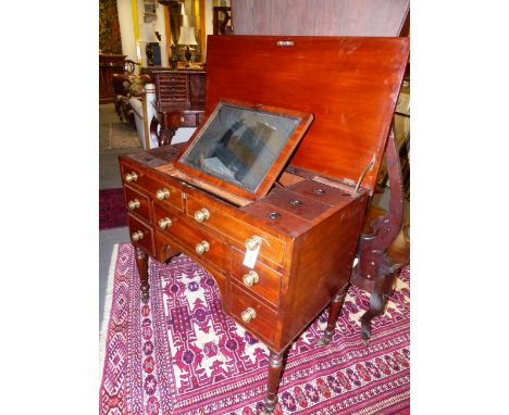 A WELL APPOINTED GENTLEMAN'S REGENCY DRESSING TABLE WITH LIFT TOP ENCLOSING A FITTED INTERIOR ABOVE FOUR DRAWERS ON RING TURN