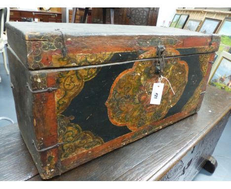 AN ORIENTAL POLYCHROME DECORATED AND IRON MOUNTED TRUNK, THE FRONT WITH A DRAGON MASK FRAMED BY SCROLLWORK.   H.39 W.77cms.