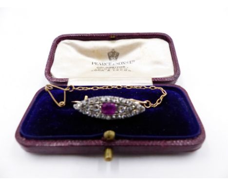 A PRECIOUS YELLOW METAL, TESTED AS GOLD, RUBY AND OLD CUT DIAMOND MARQUIS SHAPED BROOCH COMPLETE WITH SAFETY CHAIN AND FITTED