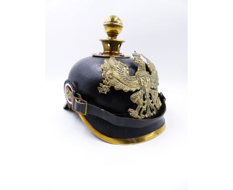 A GERMAN PICKLHAUBE HELMET WITH BLACK LEATHER SKULL AND BALL FINIAL.