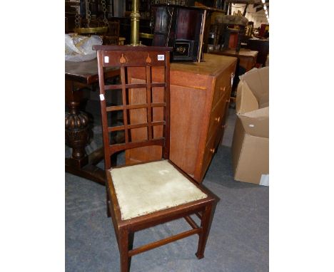 AN EARLY 20th.C.ARTS AND CRAFTS SIDE CHAIR WITH LATTICE BACK TOGETHER WITH AN ART NOUVEAU DECORATED SMOKER'S CABINET.   (2)