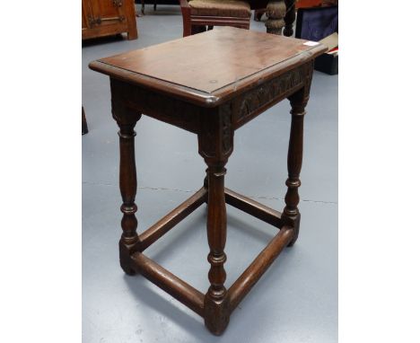 A 17th.C.AND LATER OAK JOINT STOOL WITH CARVED FRIEZE AND SPLAY LEGS.