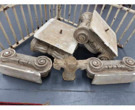 A GROUP OF ANTIQUE CARVED STONE ARCHITECTURAL ELEMENTS IN THE FORM OF SCROLLED CAPITALS.   (5)