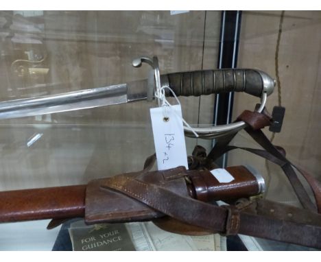 A ROYAL ARTILLERY DRESS SWORD BY WILKINSON (THE BLADE RE-EDGED) COMPLETE WITH SCABBARD TOGETHER WITH A 19th.C.NAVAL SWORD WIT